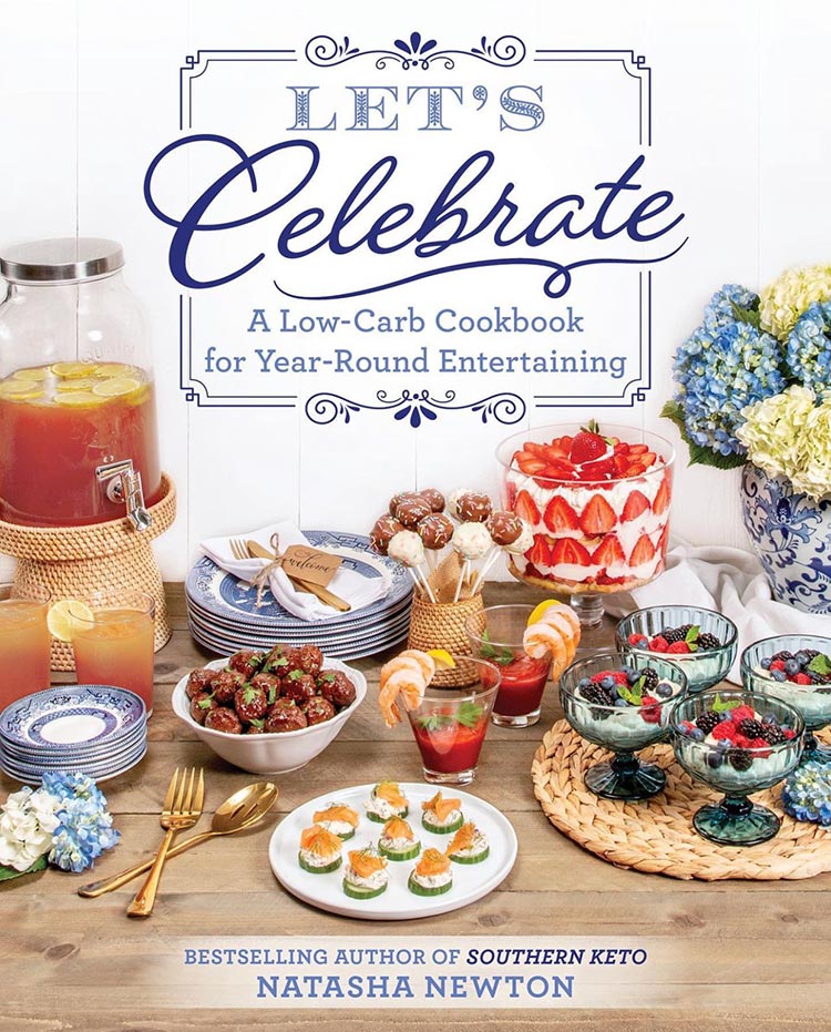 A cover of a cookbook.  Let's Celebrate.  There is an array of party foods on a table.  Blue and white hydrangeas.  Blue and white plates. 