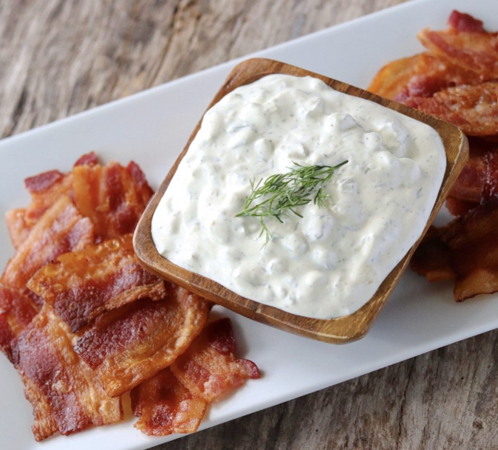 Dill pickle dip and bacon pieces for dipping.