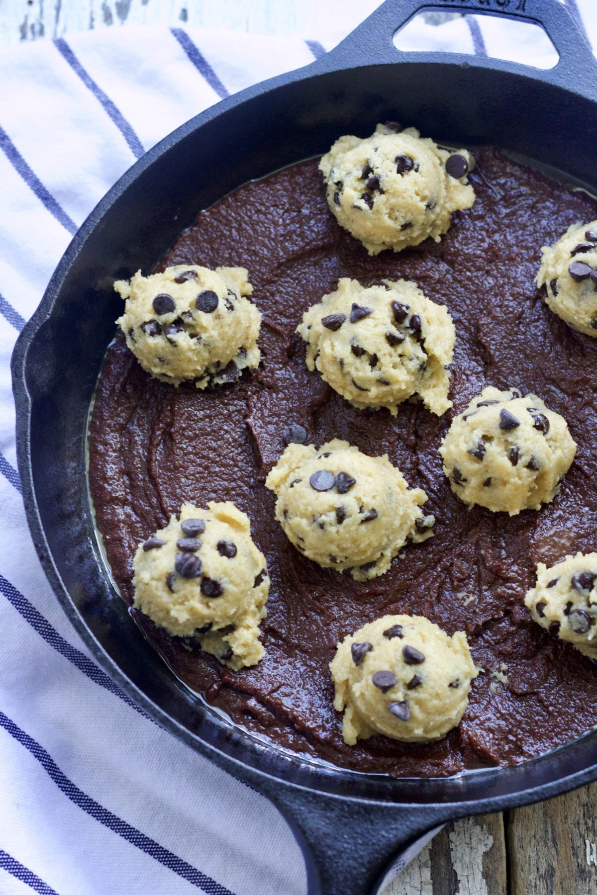 A skillet of uncooked  chocolate chip brooches.  