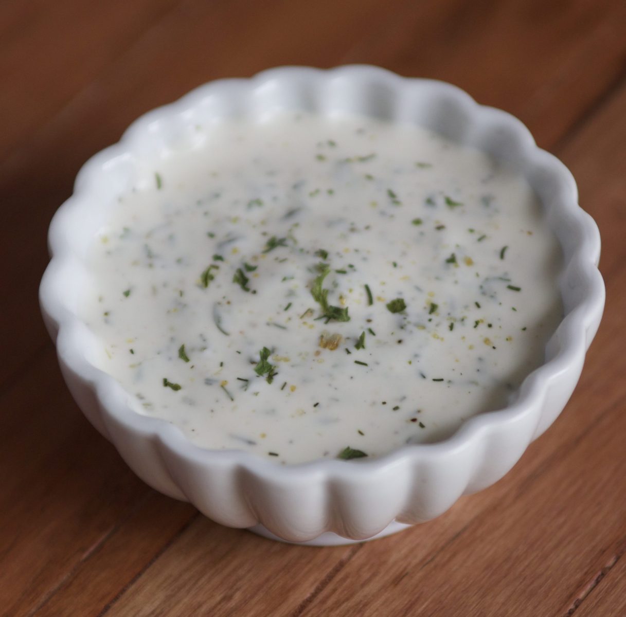 a white bowl of ranch dressing.