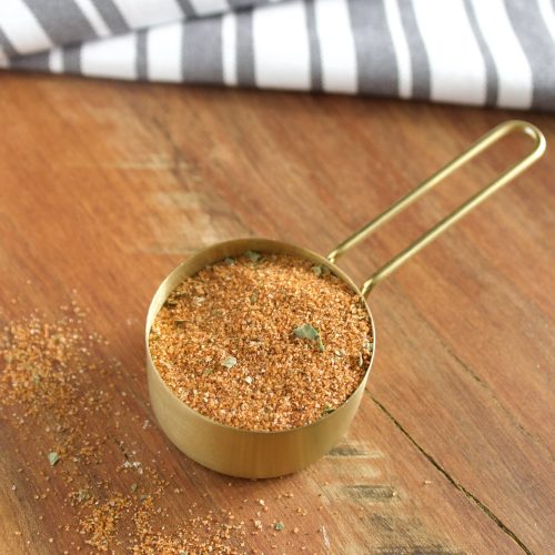 bbq rub in a gold measuring cup.