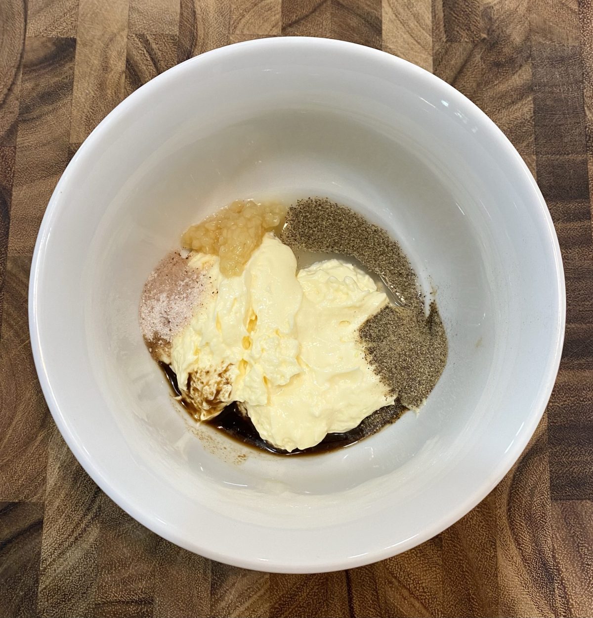 ingredients for aioli in a white bowl. 