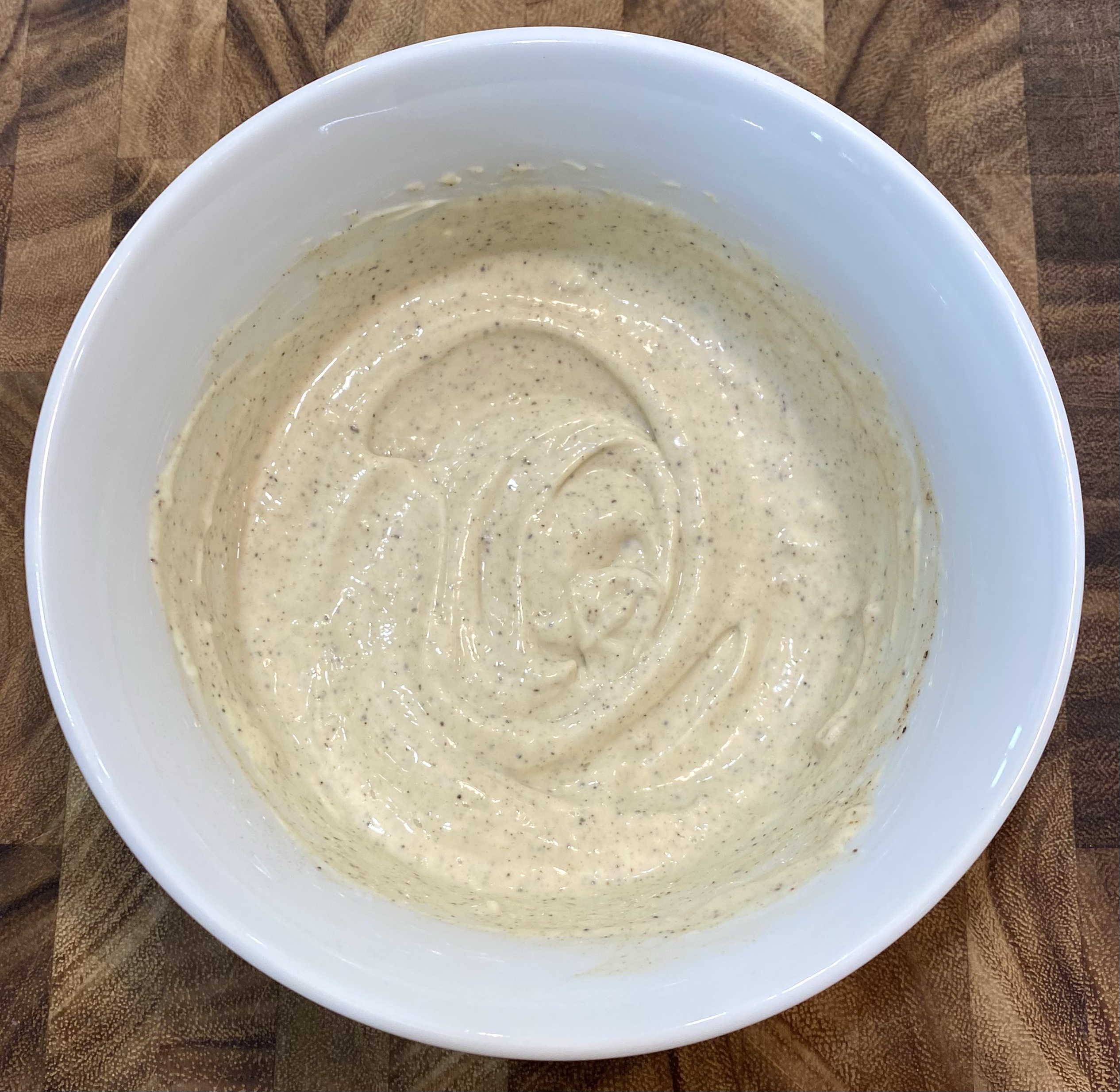 Prepared Garlic aioli in a white bowl.