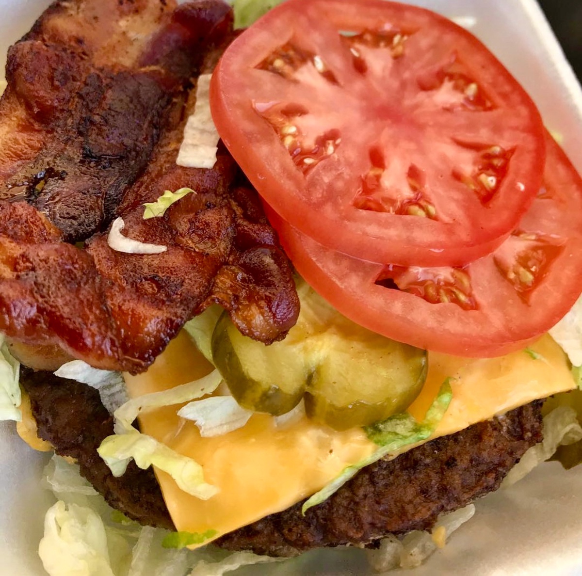 A bunless super sonic bacon double cheeseburger with tomato, pickle, lettuce and onions.