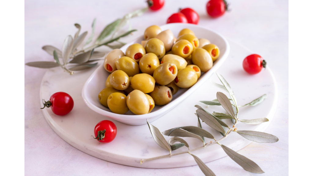 A white bowl with stuffed olives.
