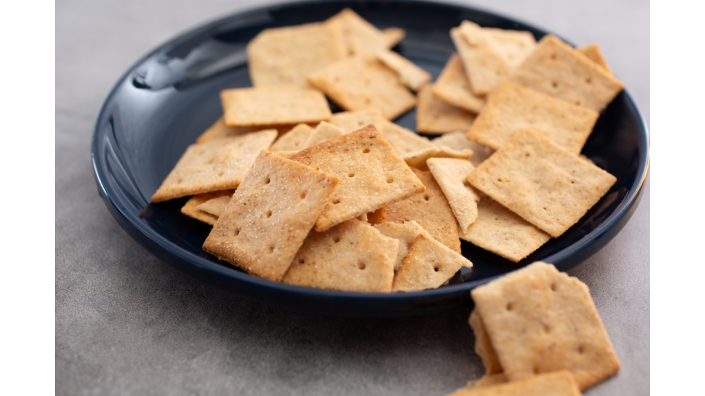 A black plate with low carb almond flour crackers. 