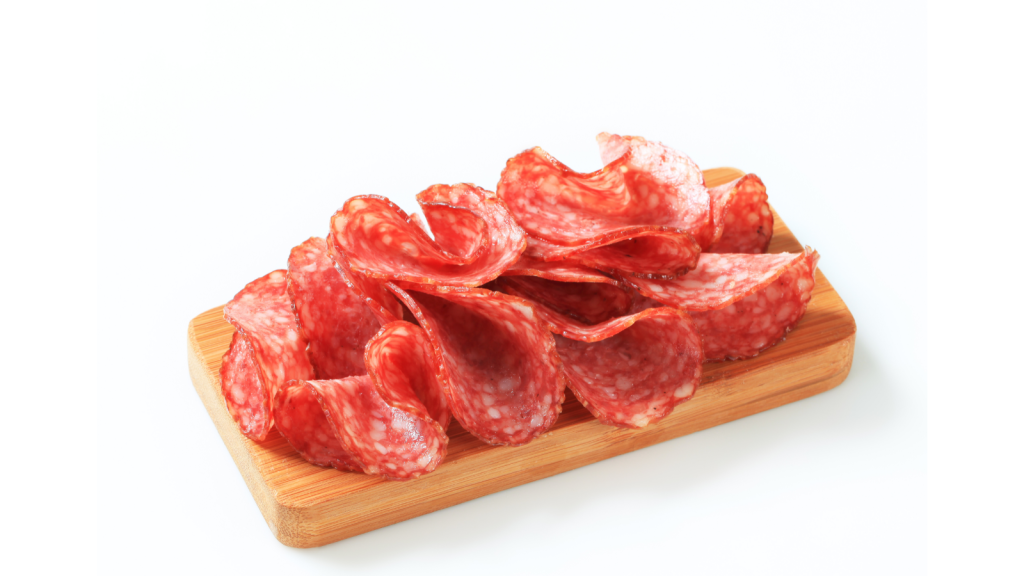 sliced salami on a wooden board. 