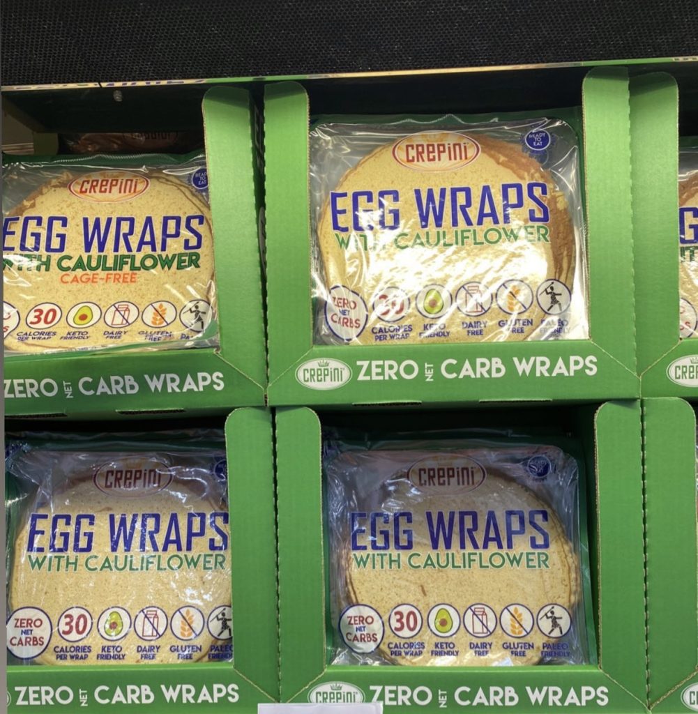 Packages of egg white wraps on a warehouse store shelf.