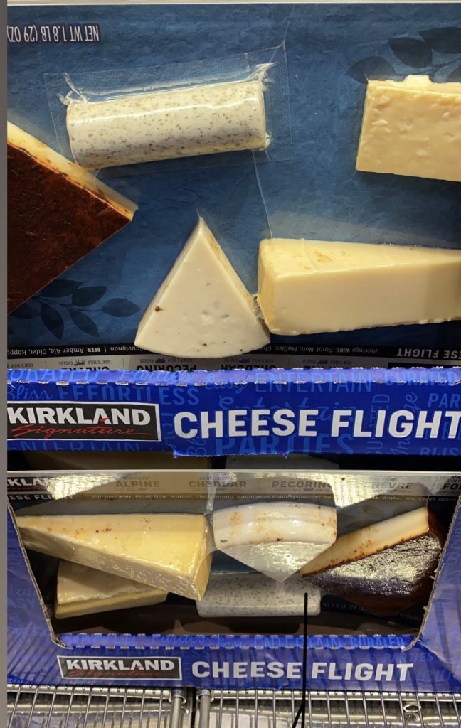 packaged flights of cheese on a shelf.