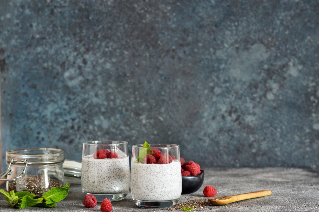 Chia pudding and berries in clear glasses.