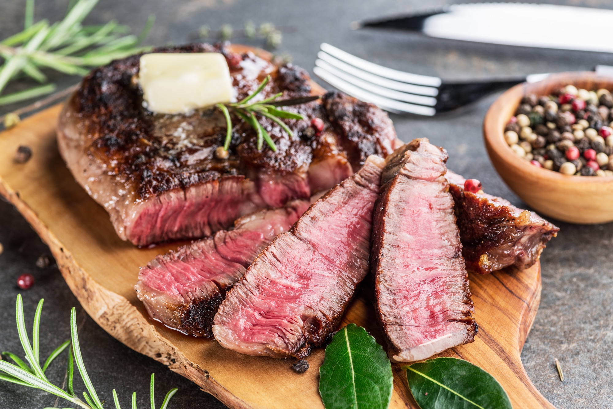 Ribeye steak with butter and rosemary.