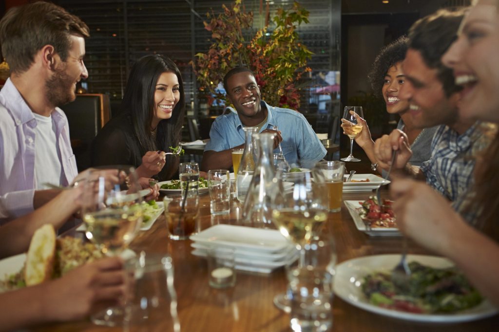 Friends gathered around a restaurant table.