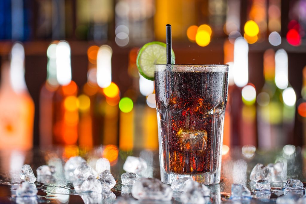 Cola in a glass on a bar top. 