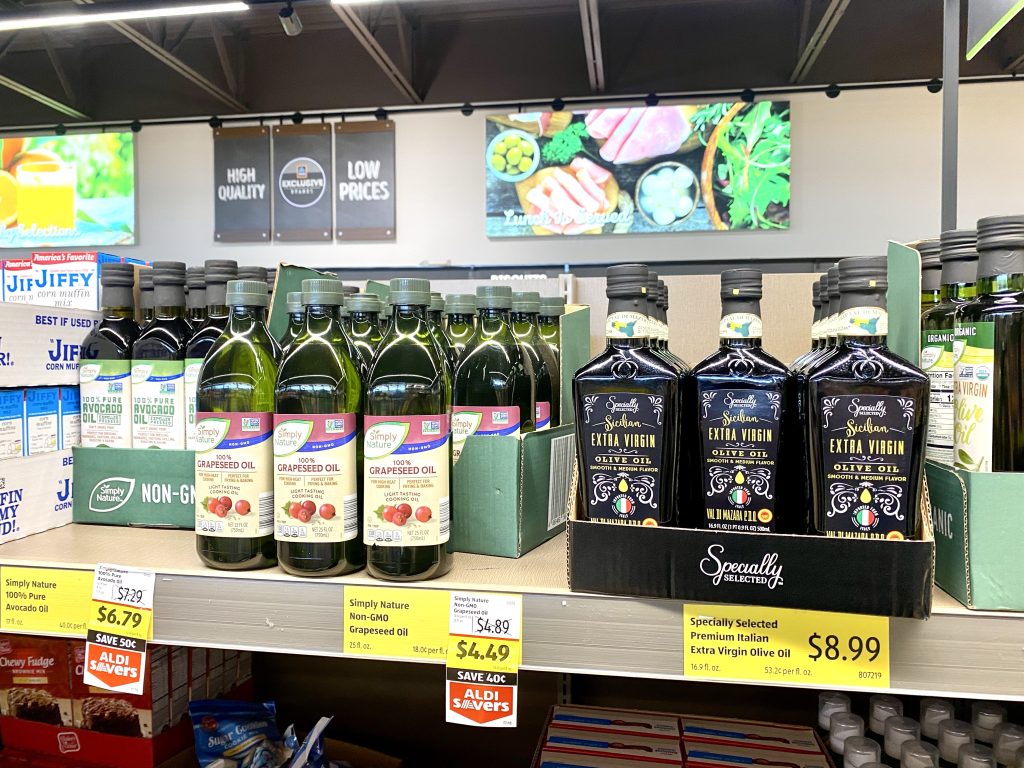 bottles of cooking oils on shelf at grocery store.