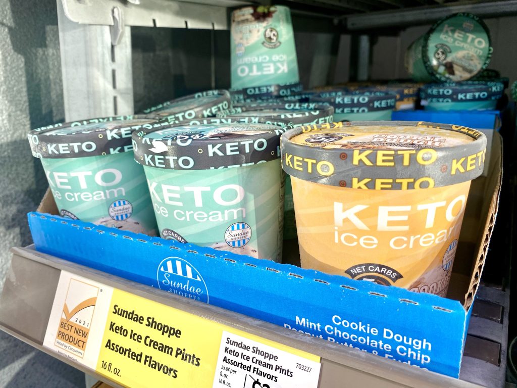 Pints of ice cream on store shelf.