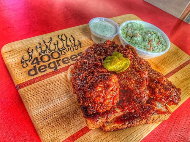 A wood board with 400 degrees hot chicken on it.