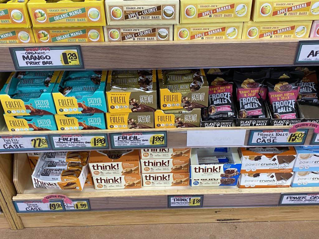 Protein bars on grocery store shelf.