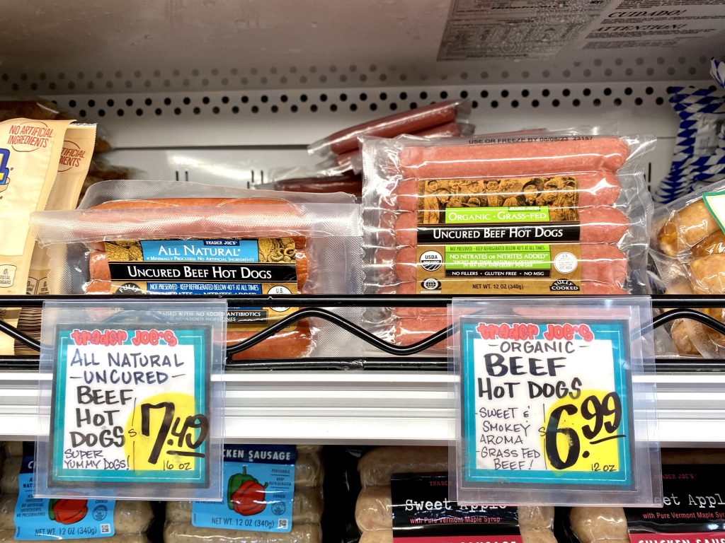 Uncured beef hotdogs in grocery store cold case.