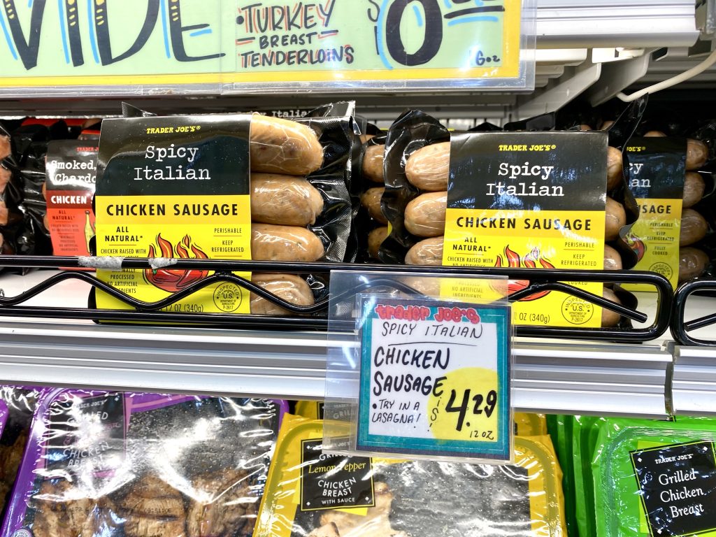 Chicken sausages on grocery store shelf.