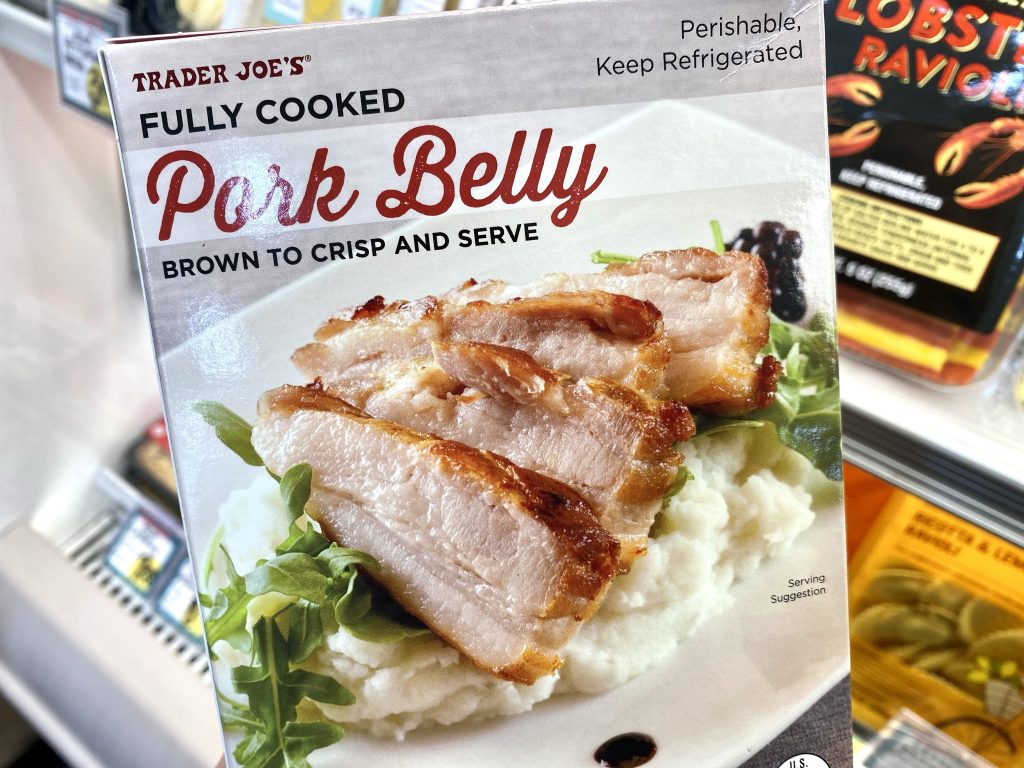 Pork belly in package on grocery store shelf.