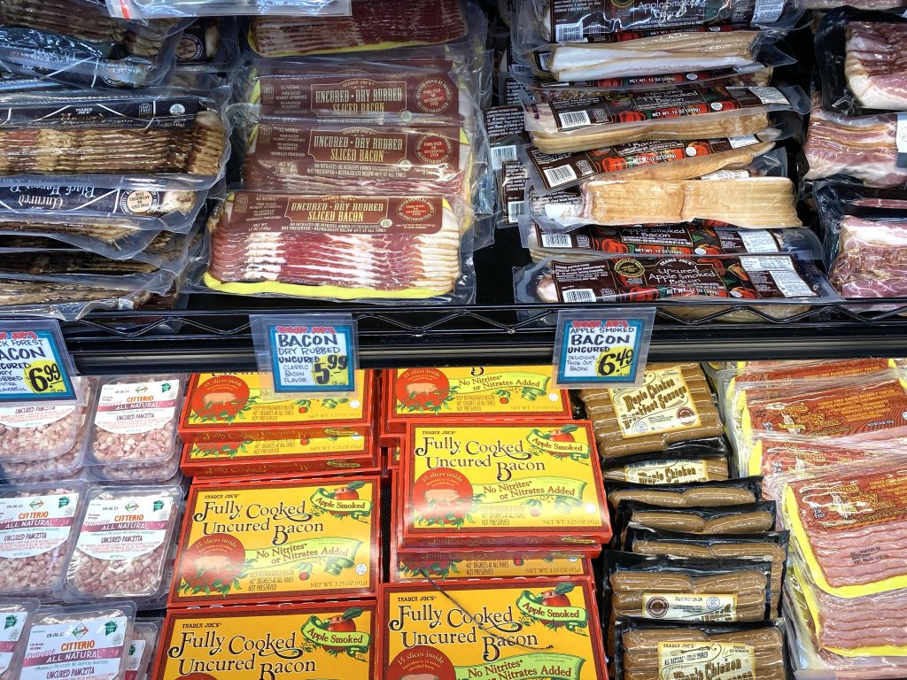 Uncured bacon in case at grocery store.