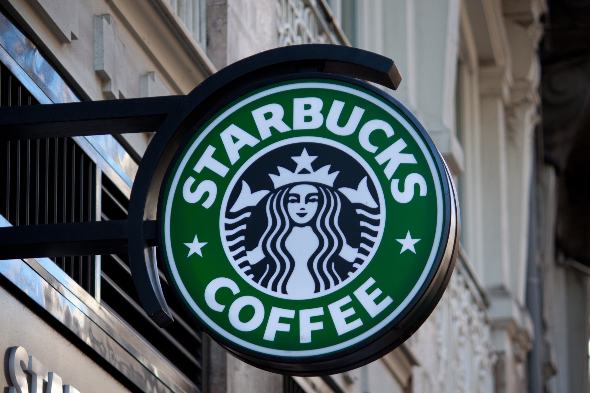 Starbucks sign hanging from building