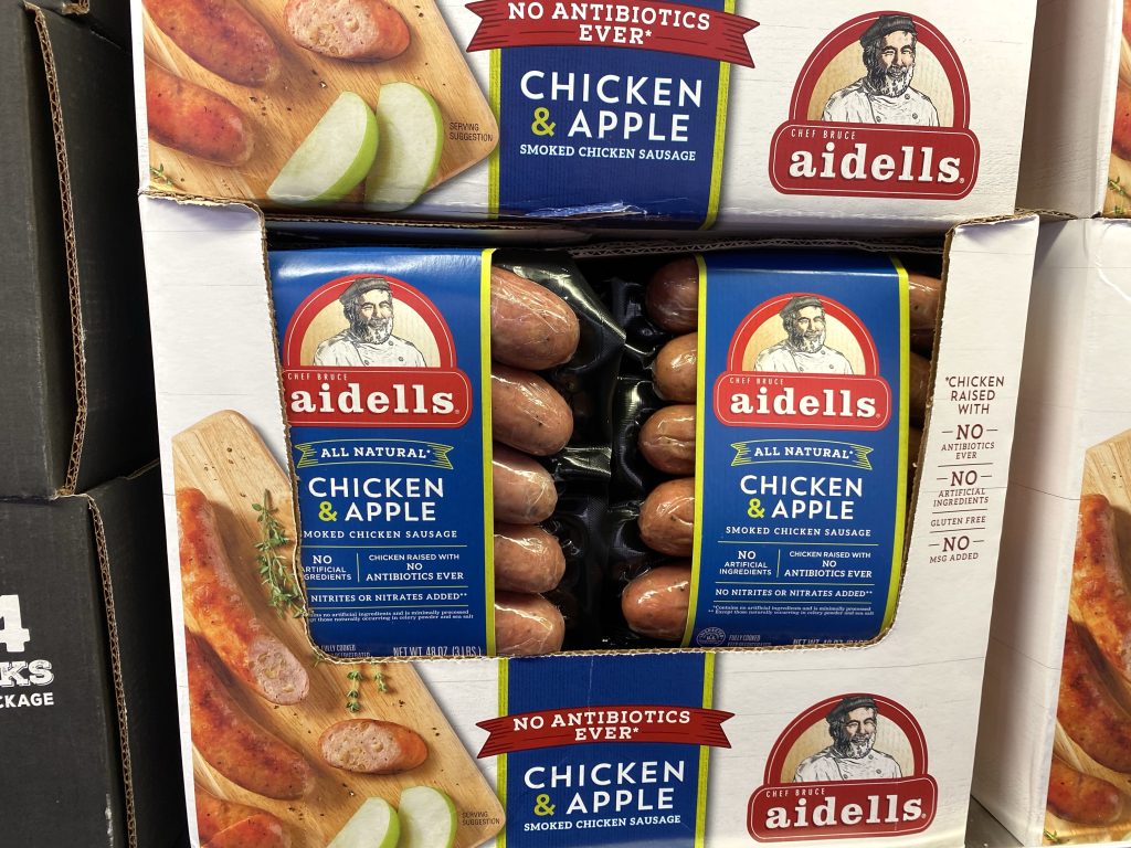 Chicken sausages on grocery shelf.