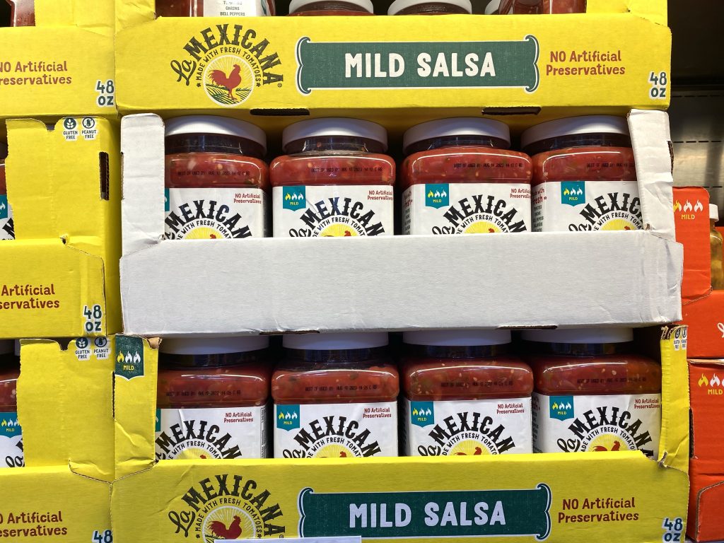 Salsa on shelf at grocery store.