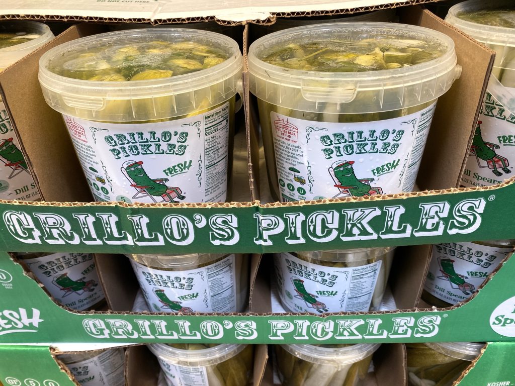 Dill pickles on grocery shelf.