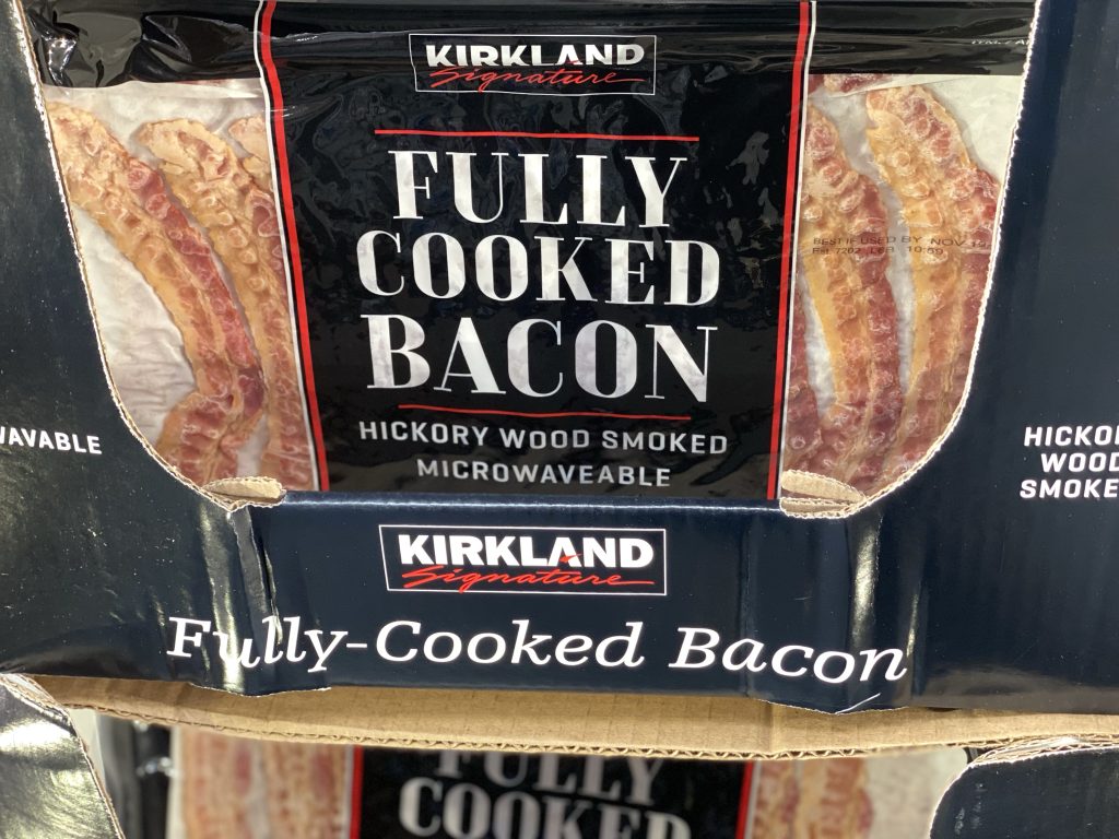 Bacon on shelf at grocery store.