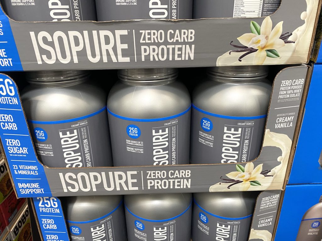 Whey protein powder on grocery shelf.