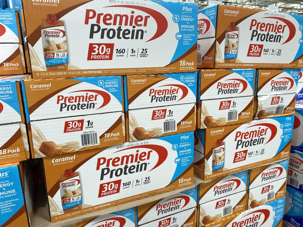 Protein shakes on grocery shelf.
