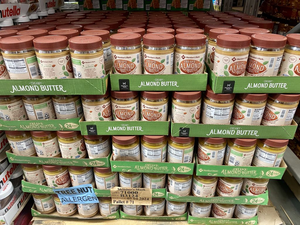 Jars of almond butter on grocery shelf.