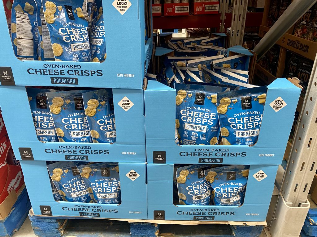 Packages of no Parmesan crisps on grocery shelf.