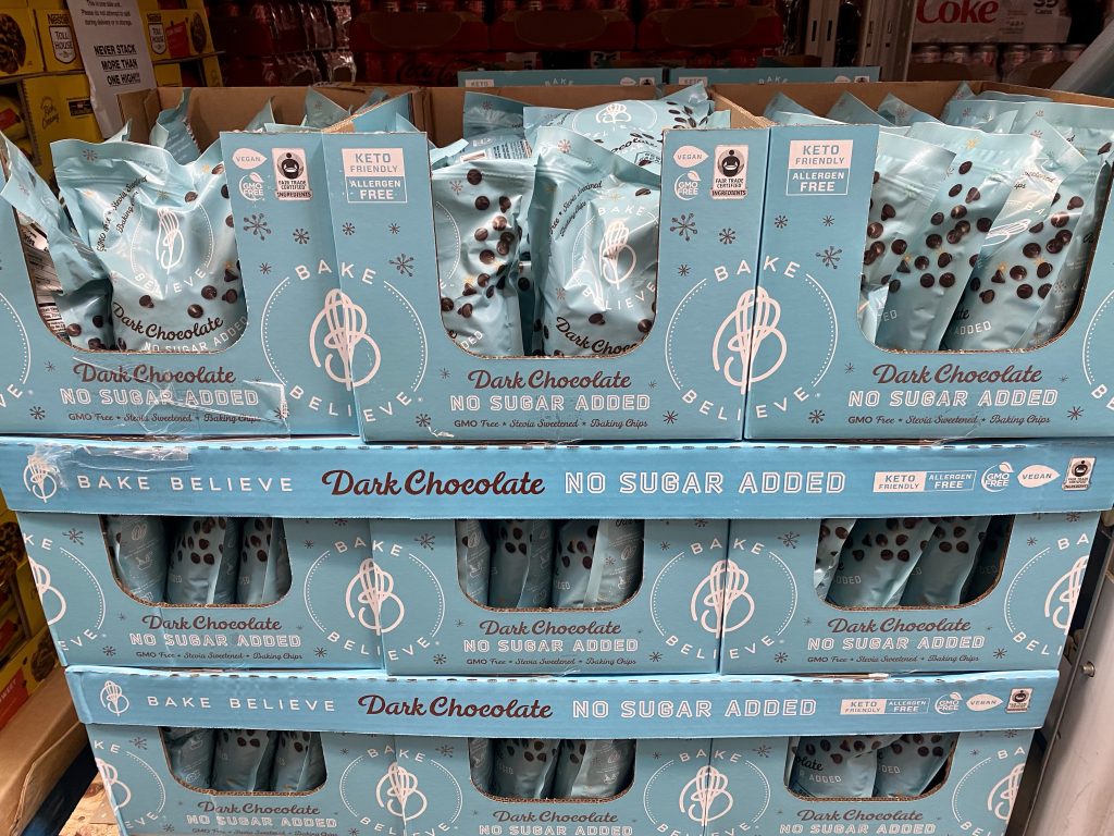 Packages of no sugar-added chocolate chips on grocery shelf.