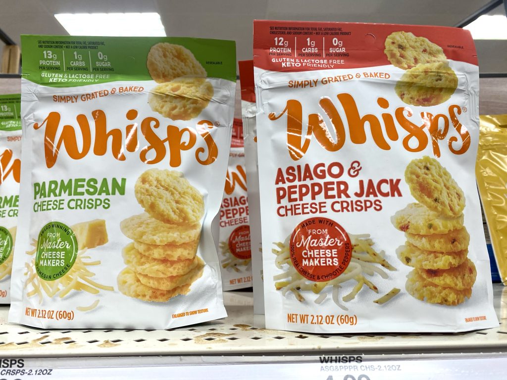 Cheese crisps packages on grocery store shelf.