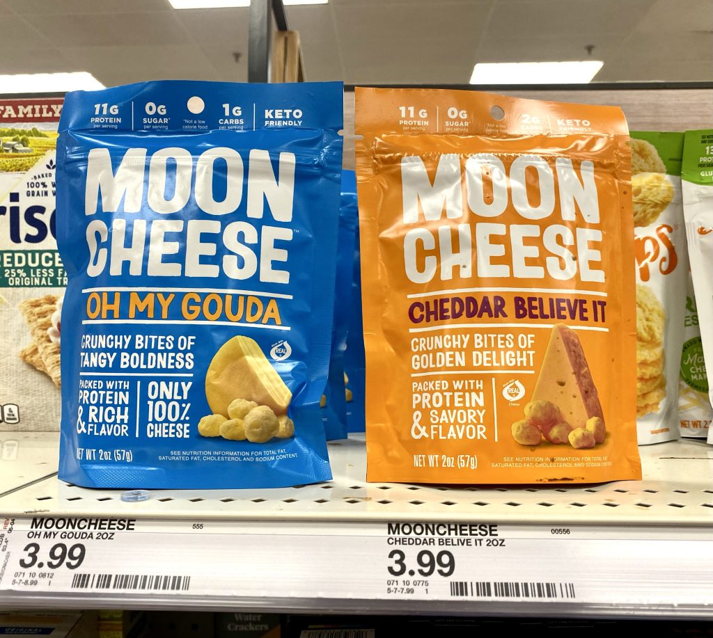 Packages of moon cheese on shelf at store.