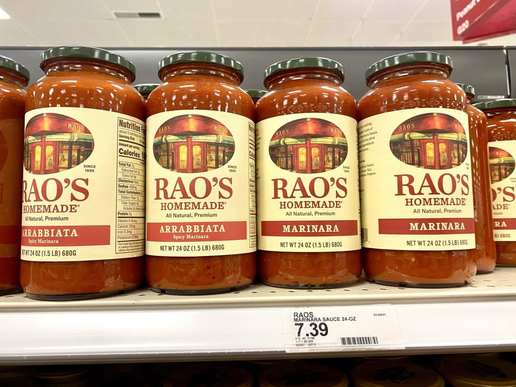 Jars of marinara sauce on grocery store shelf.