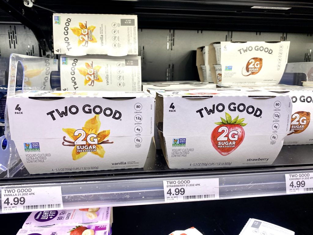 Low carb yogurt cups on grocery store shelf.