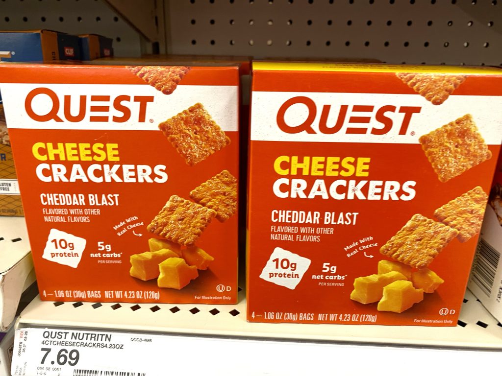 Packages of low carb crackers on store shelf.