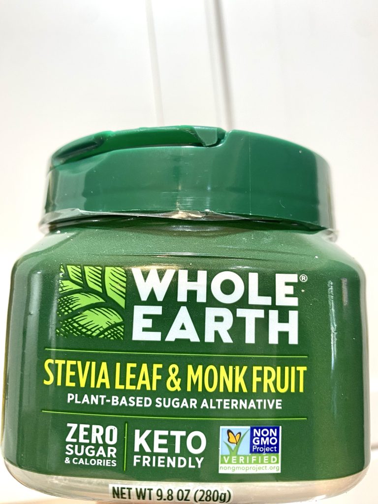 A green jar of whole earth stevia and monk fruit sweetener.