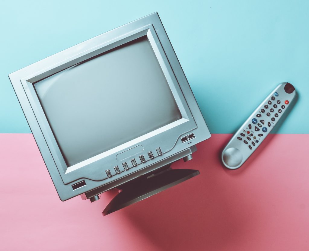 overhead view of a vintage television and remote control.