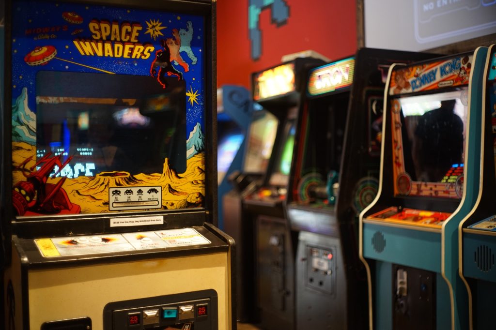 A vintage arcade with game cabinets.  The one in front says space invaders.