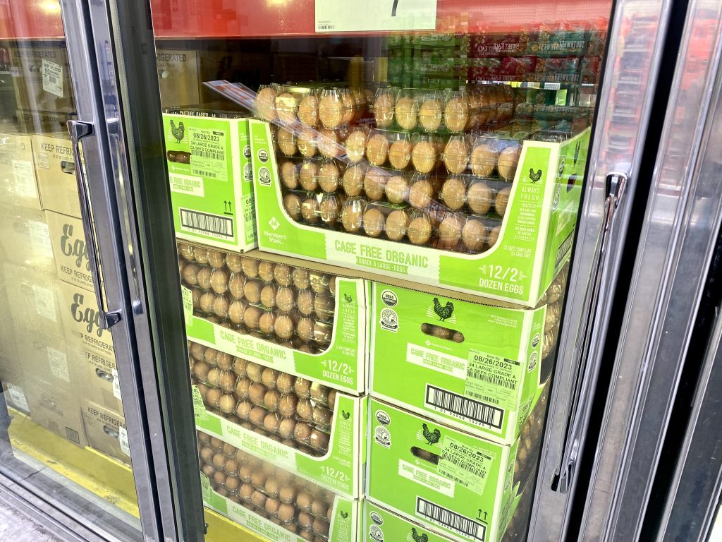 Dozens of eggs in cooler at grocery store.