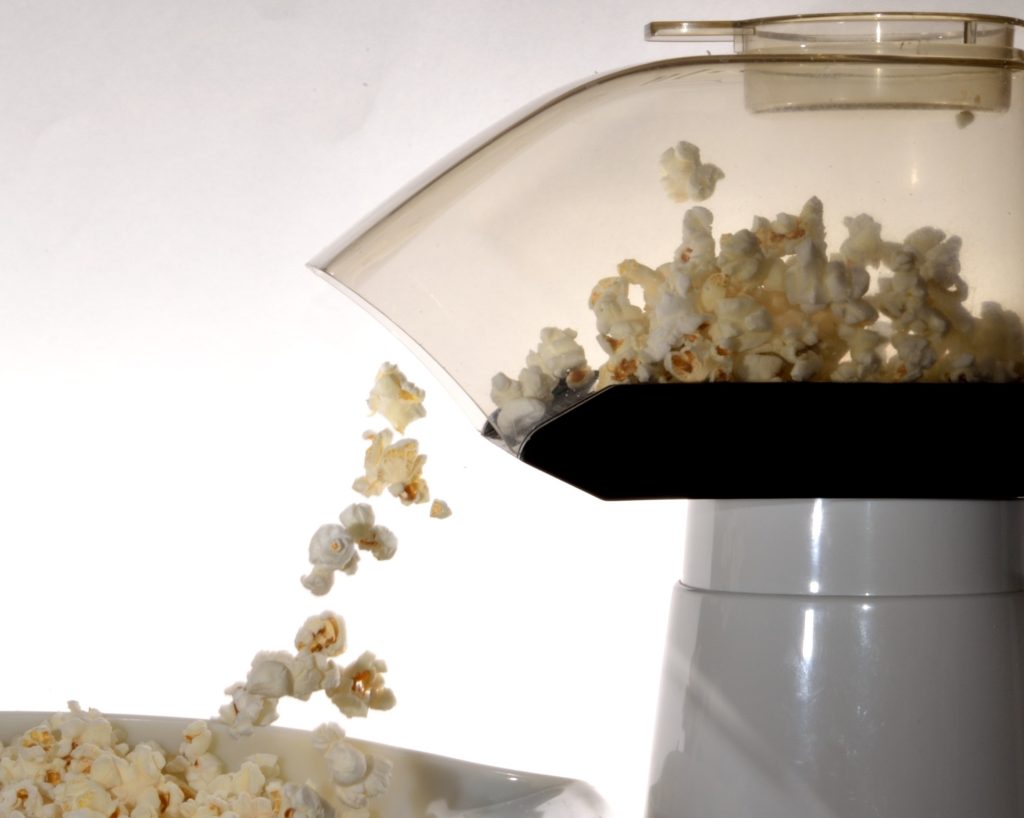 Popcorn maker, popcorn falling out of the spout.