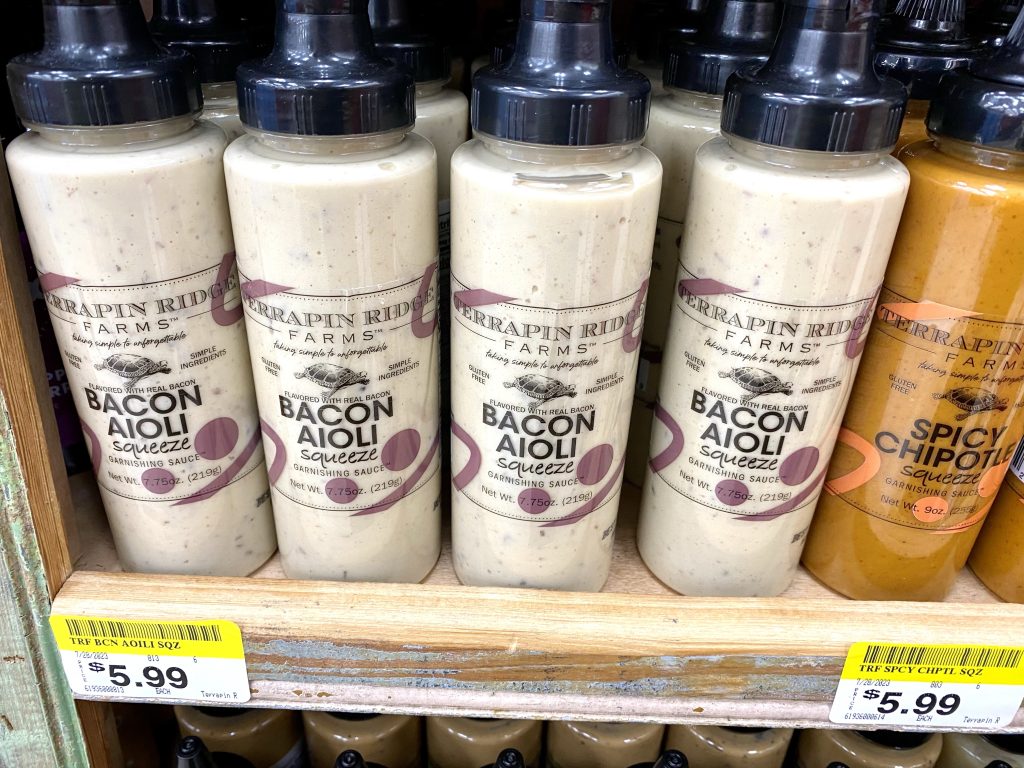 Bottles of Bacon aioli on store shelf.