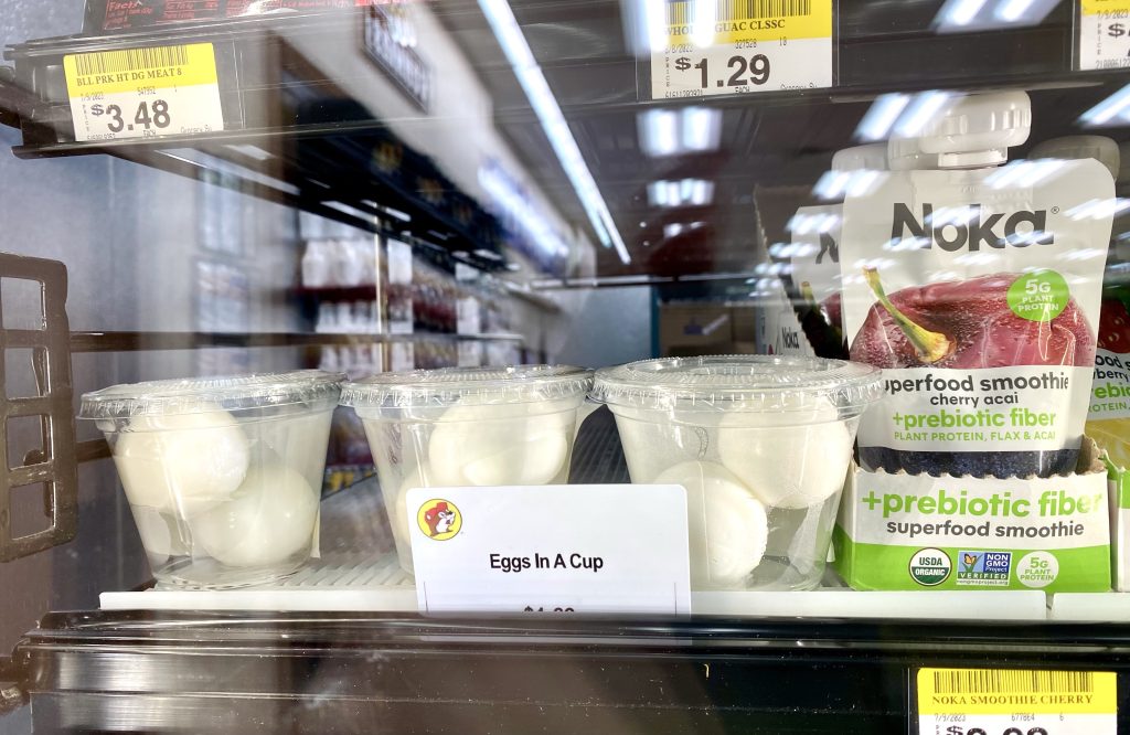 Plastic cups of hard boiled eggs in refrigerated cooler at Buc-ee's