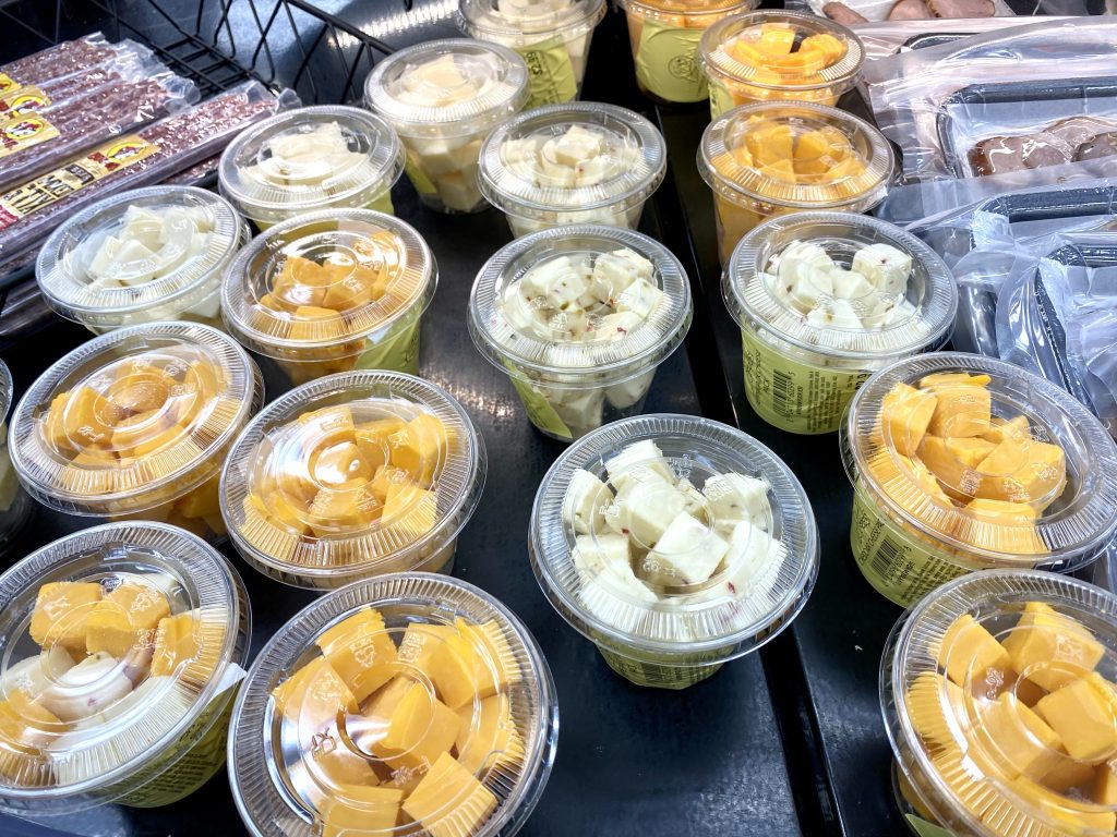 Plastic Cups of cheese blocks packaged as snacks at convenience store.