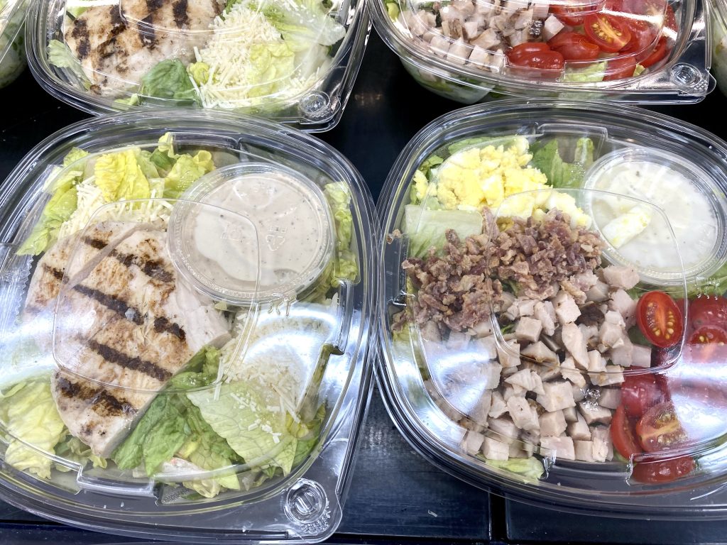 Ready made salads in plastic containers at convenience store.