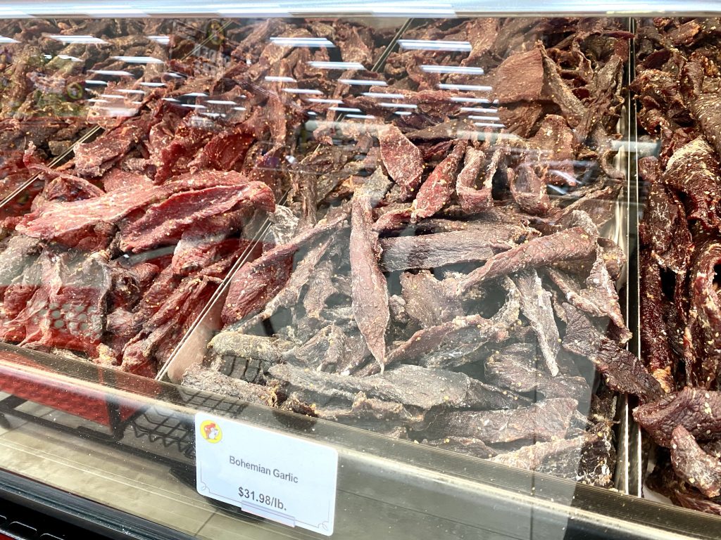 Homemade beef jerky in a glass case at Buc-ee's.
